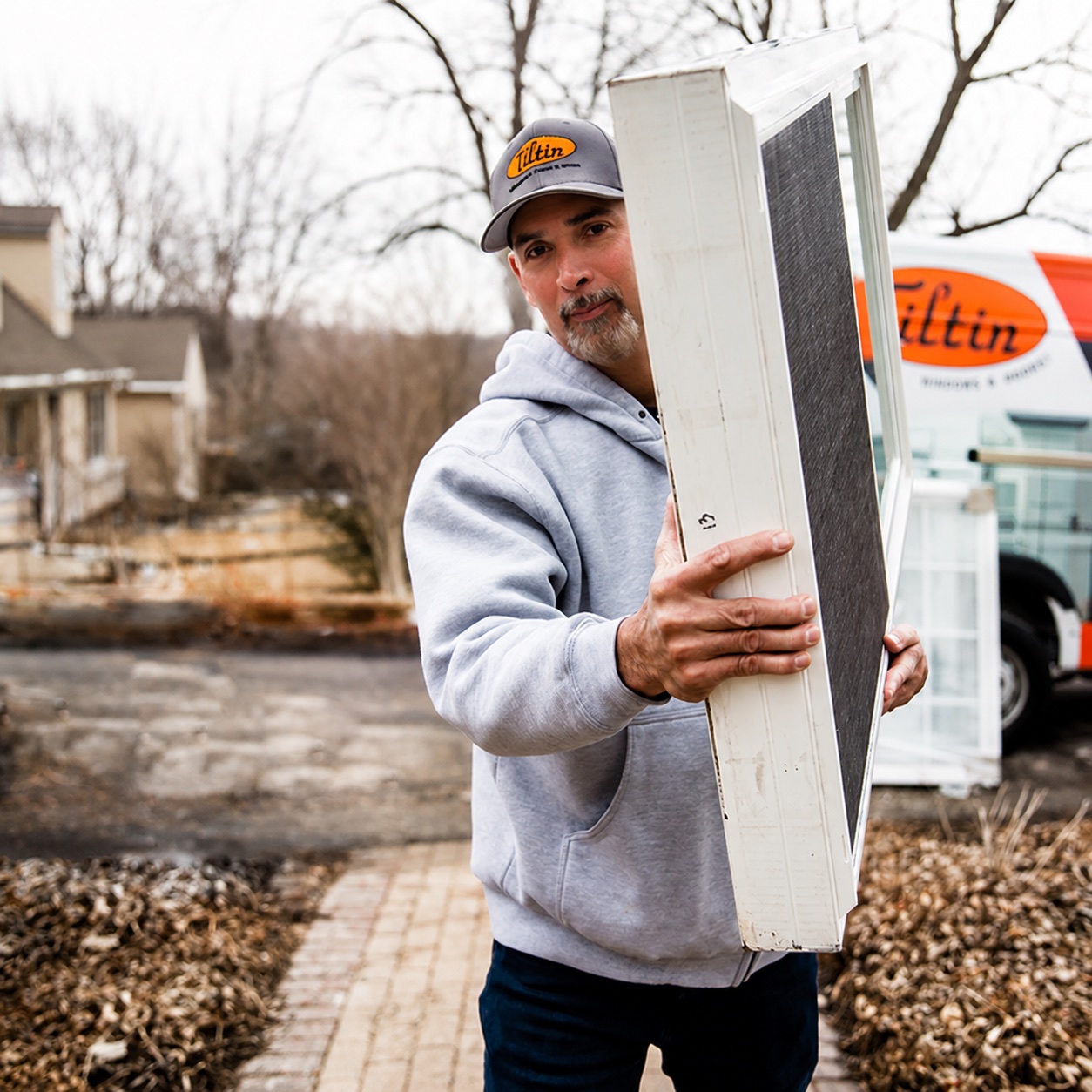 Tiltin installer carrying a replacement window